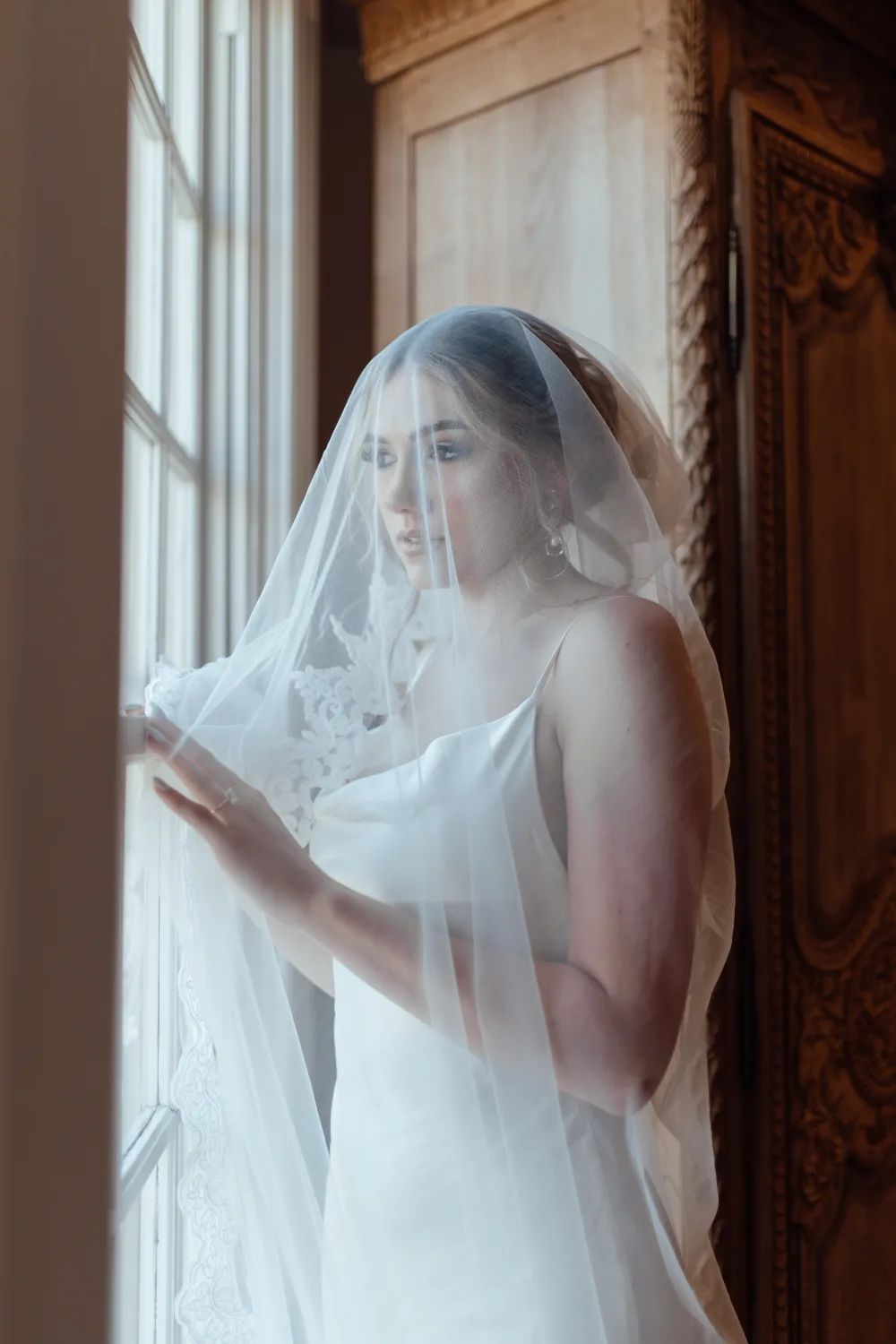 Bridal portrait under a veil in window light