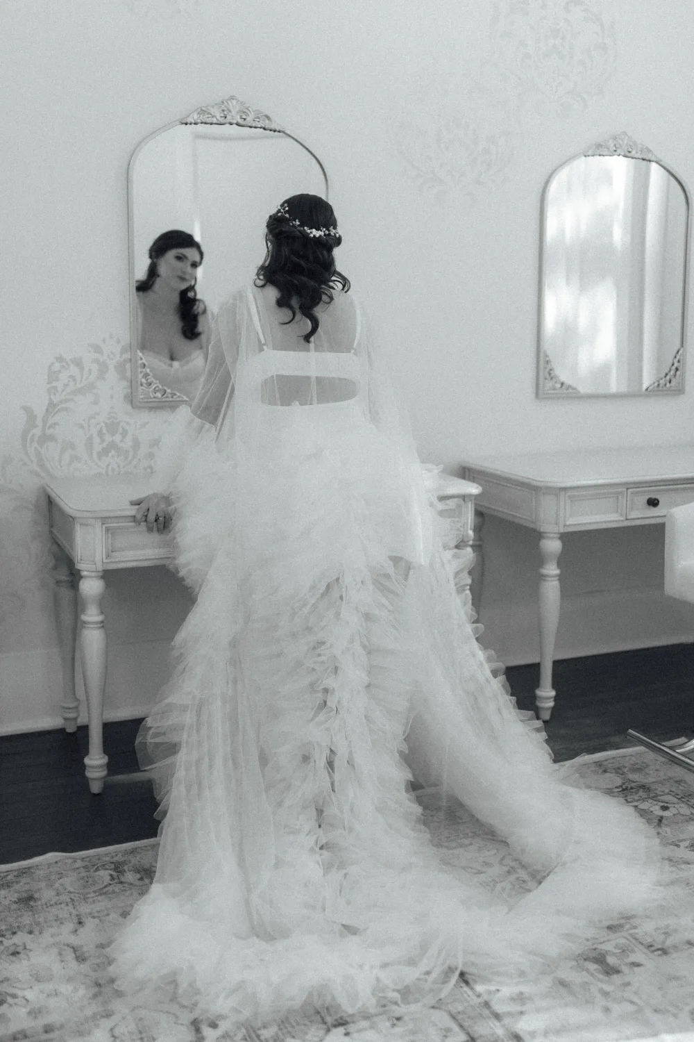 Black and white view of a bridal hairstyle in a mirror